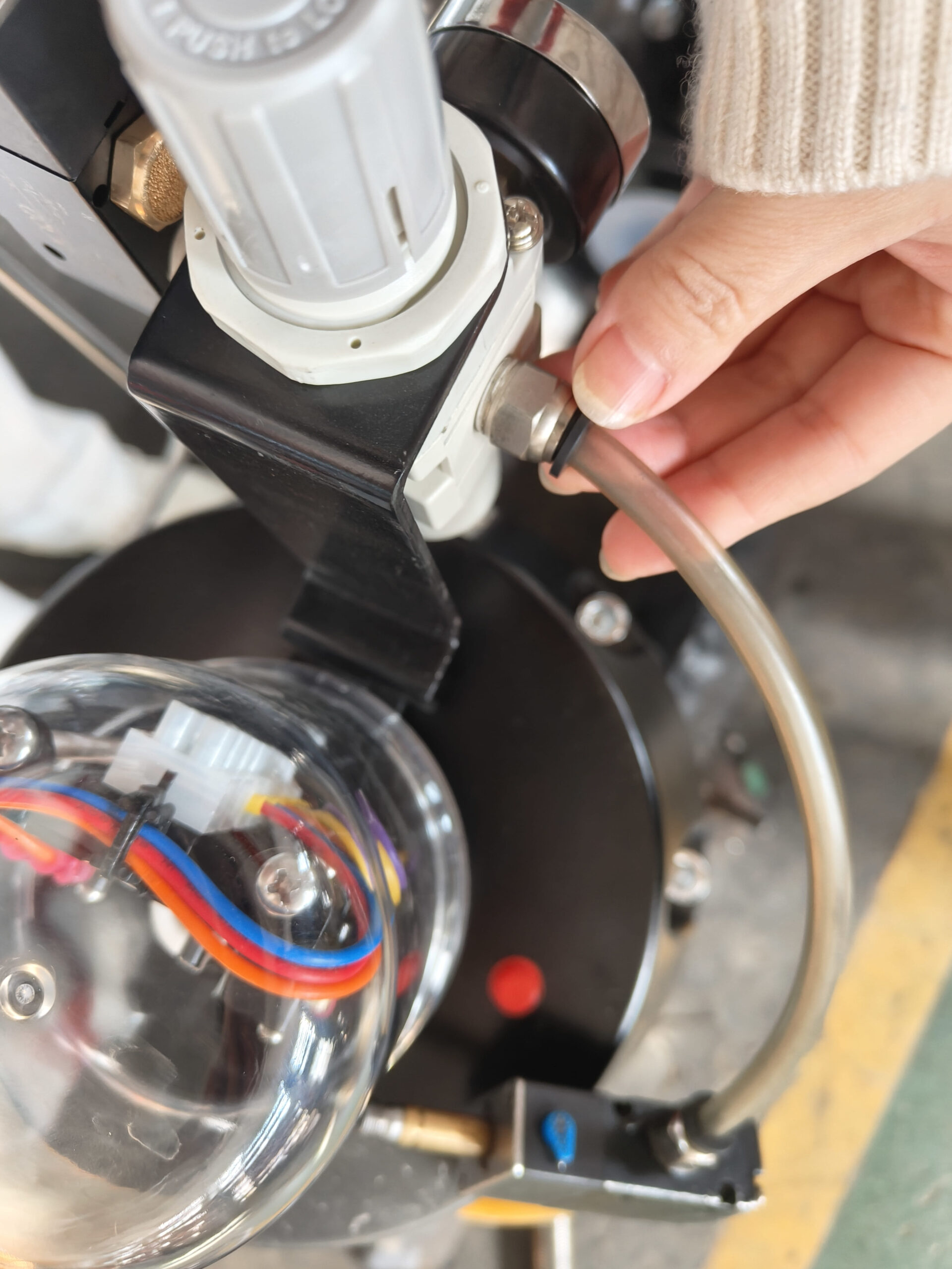 A technician checking the alignment of a pneumatic actuator on a diaphragm valve.